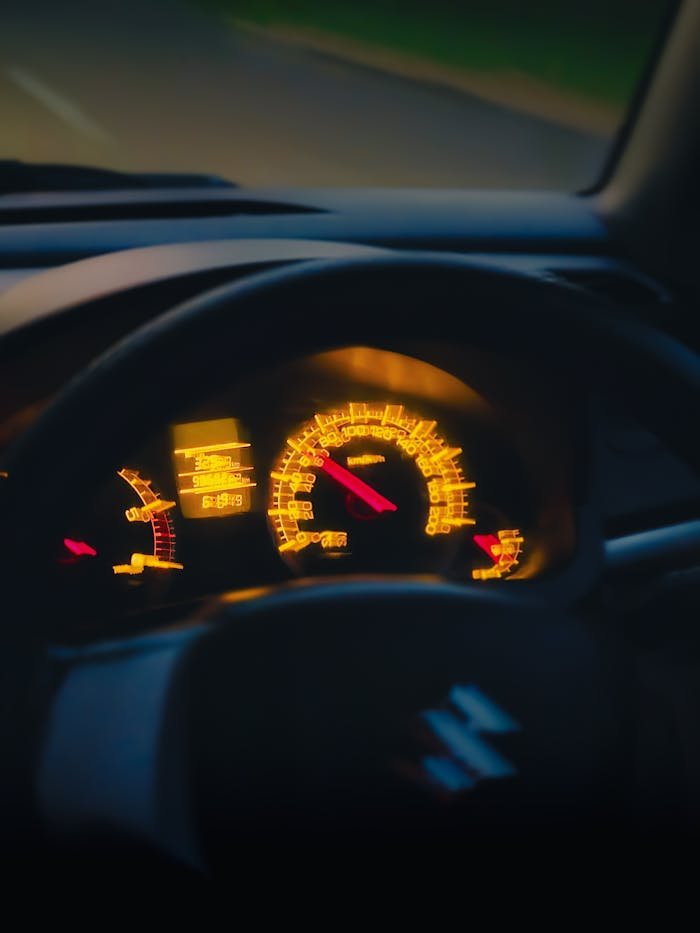 creative-03 Close-up of a car dashboard glowing during nighttime drive.