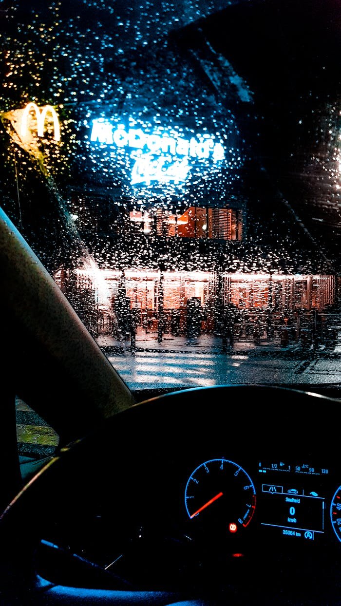 brand-03 View of McDonald's through a rainy windshield at night.