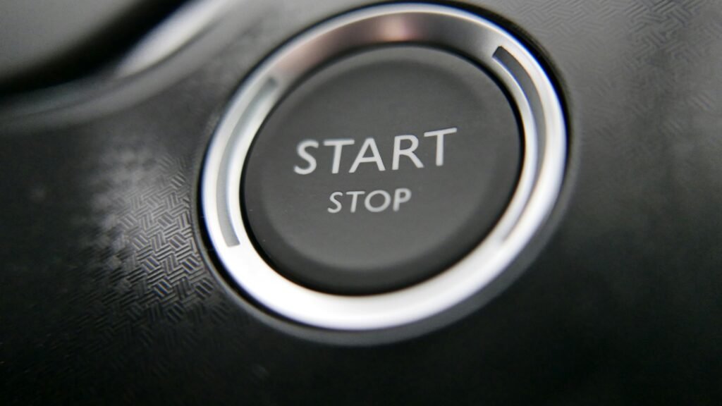 pexels photo 5680771 5680771 Close-up of a car's keyless ignition button with start and stop options.