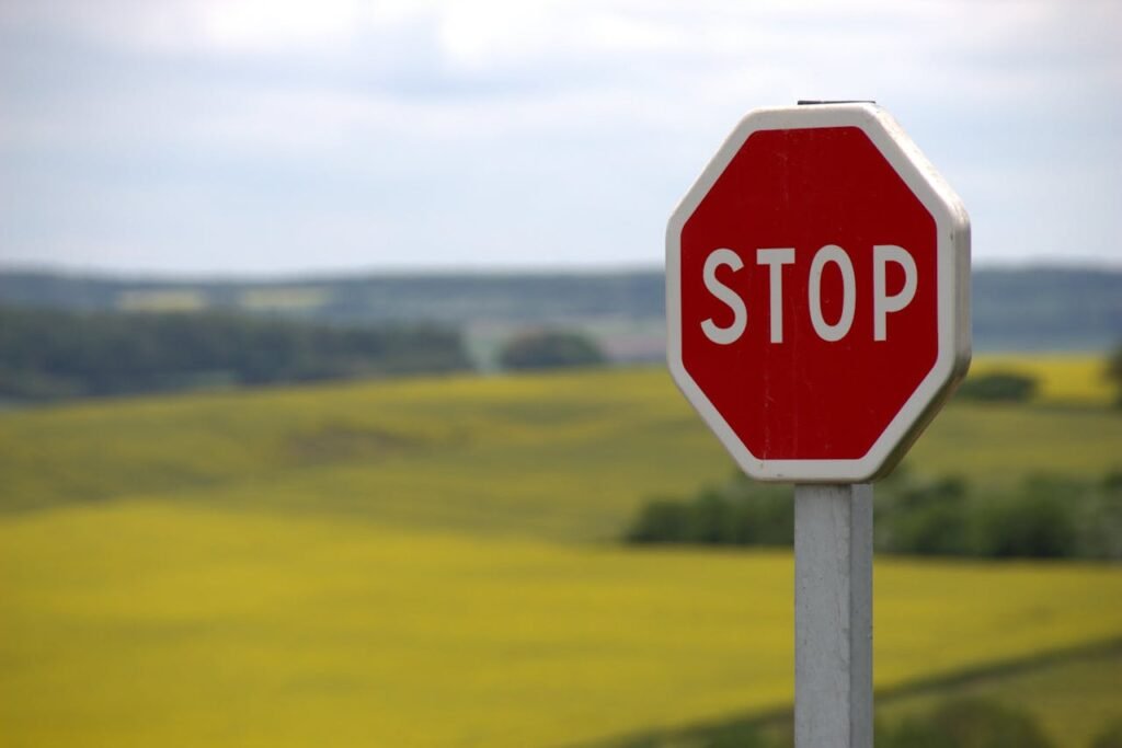 stop shield traffic sign road sign 39080 A stop sign stands alone against a rural landscape in Schweyen, France.